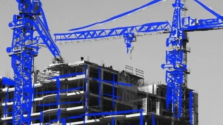 Two tower cranes over a building under construction, in black and white with the steelwork traced in blue.